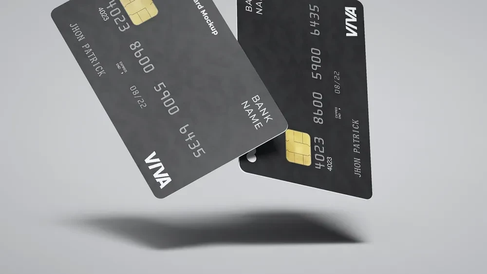 Tarjeta de débito delante de un gráfico financiero, imagen ilustrativa